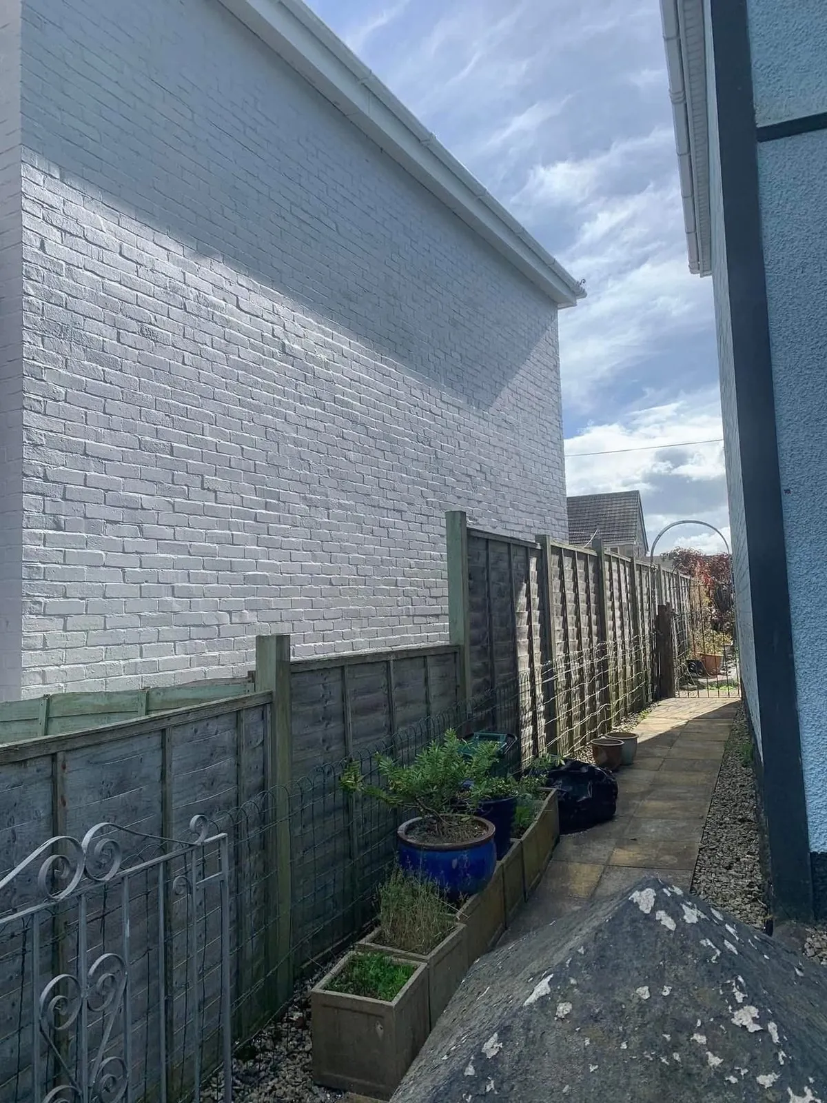 Freshly painted brick wall after preparation and masonry paint in Saltash